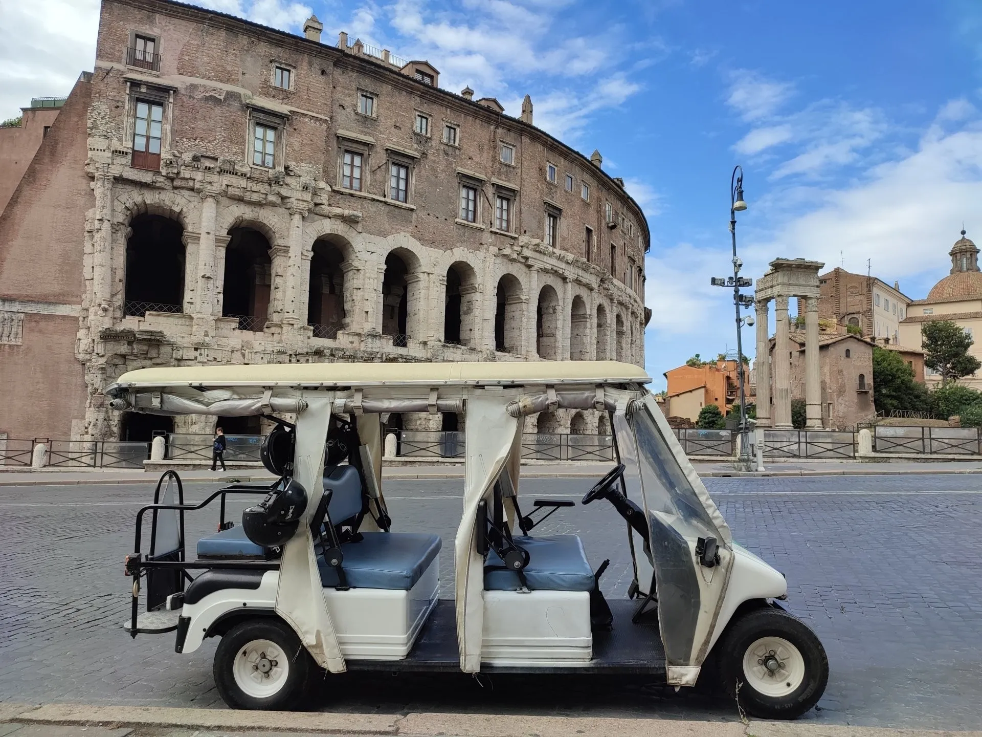 Our golf cart parked by the Theatre of Marcellus on a sunny morning (real photo)